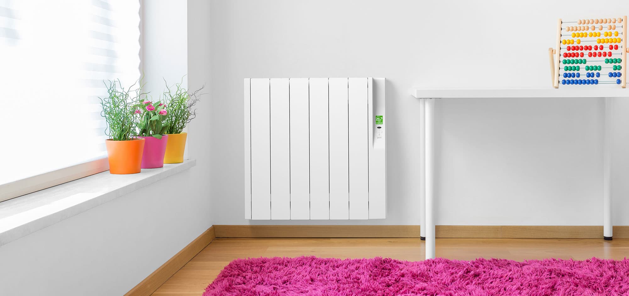 Rointe Sygma oil-filled radiator wall-mounted in white in childrens bedroom with pink carpet and abacus